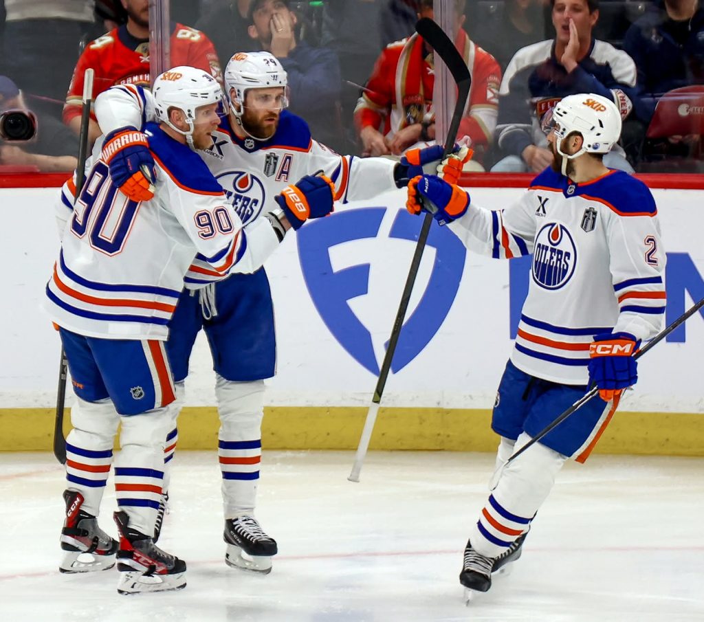 SUNRISE, FL - JUNE 09: Edmonton Oilers Right Wing Corey Perry (90) celebrates his goal with Edmonton Oilers Center Leon Draisaitl (29) and Edmonton Oilers Defenseman Evan Bouchard (2) during the Stanley Cup Final game three between the Edmonton Oilers and the Florida Panthers on June 9, 2025 at Amerant Bank Arena in Sunrise, Fla. (Photo by Chris Arjoon/Icon Sportswire via Getty Images)